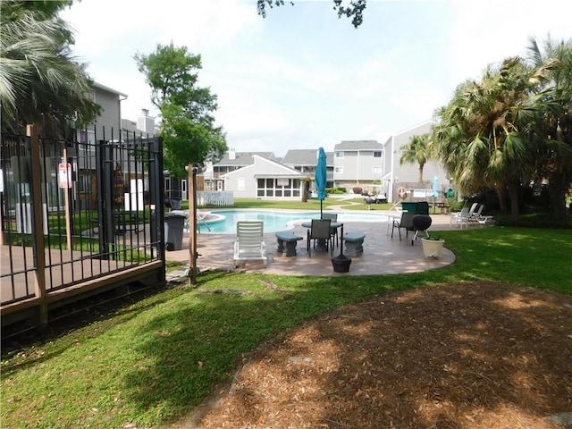 view of pool with a yard and a patio