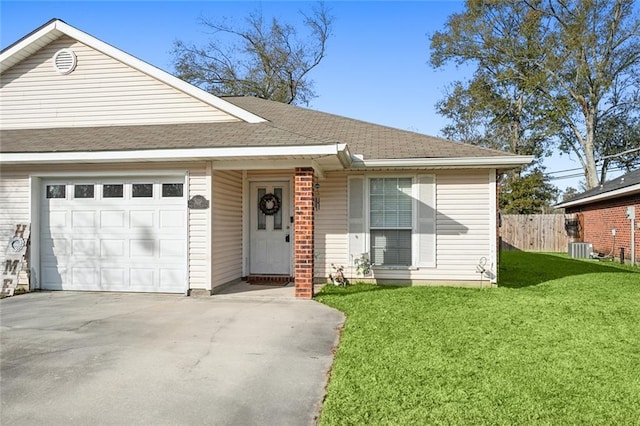 view of front of property with a front yard, a garage, and central air condition unit