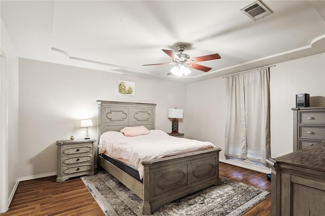 bedroom with dark hardwood / wood-style flooring and ceiling fan