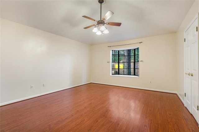 empty room with hardwood / wood-style floors and ceiling fan