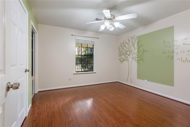 empty room featuring visible vents, baseboards, ceiling fan, wood finished floors, and a textured ceiling