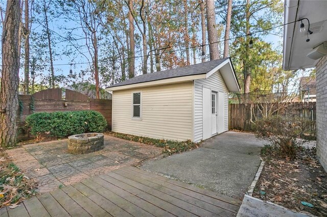 view of outbuilding with an outdoor fire pit