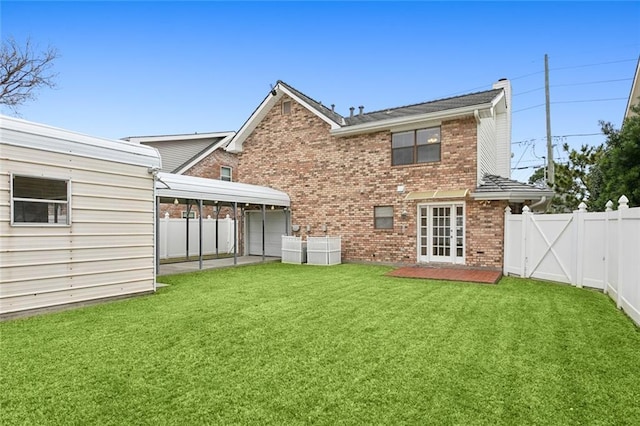 back of house with a yard, cooling unit, and french doors