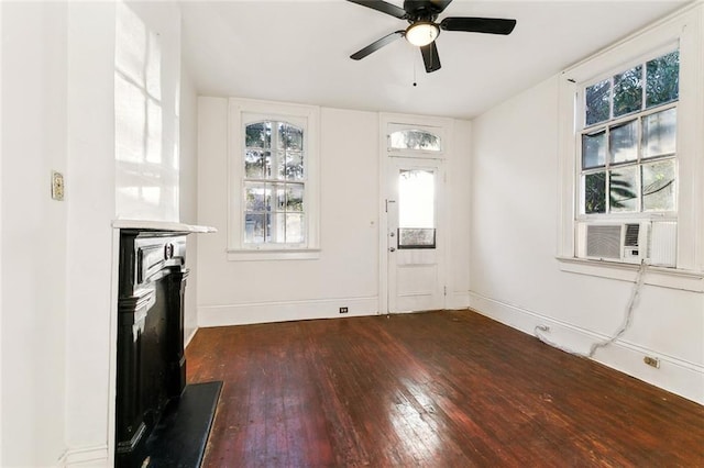 unfurnished living room featuring dark hardwood / wood-style floors, cooling unit, and ceiling fan