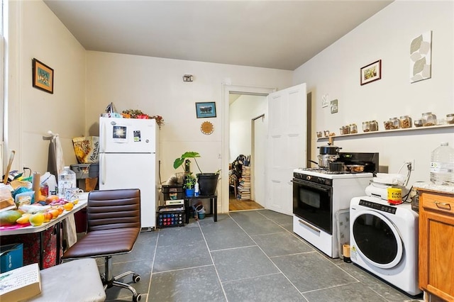 kitchen featuring washer / dryer and white appliances