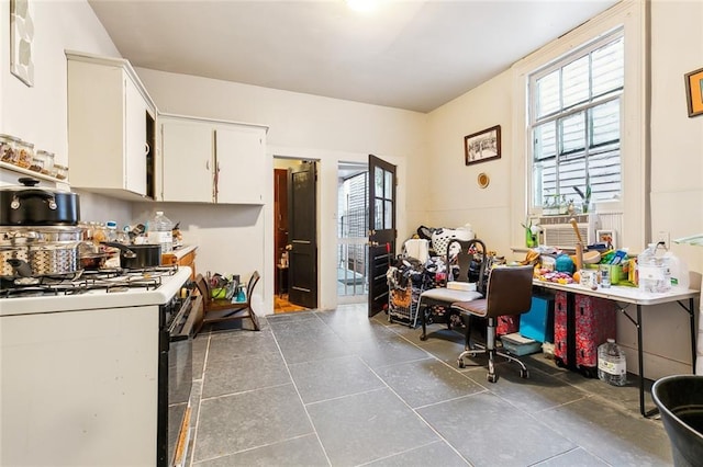 kitchen with white cabinets and white gas stove