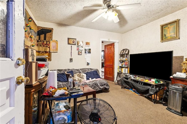 carpeted living room featuring ceiling fan and a textured ceiling