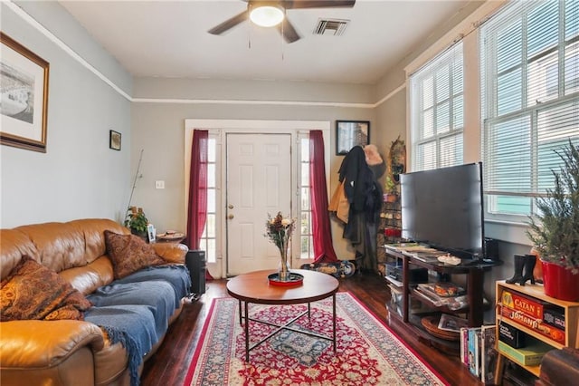 living room featuring ceiling fan and dark hardwood / wood-style floors