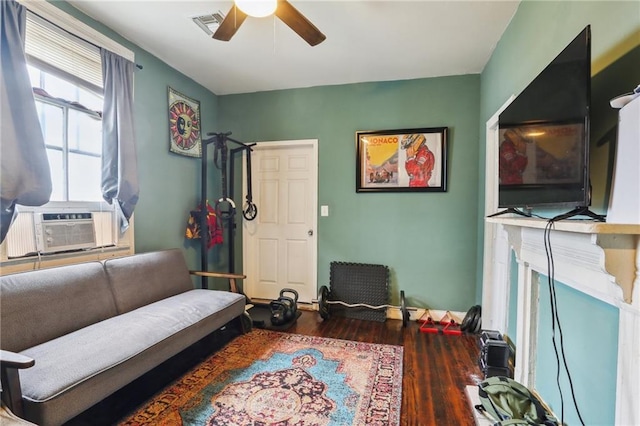 living area with ceiling fan and dark hardwood / wood-style flooring