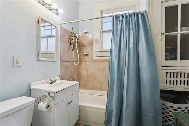 full bathroom with a wealth of natural light, vanity, shower / tub combo, and toilet