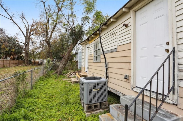 view of side of home with central AC