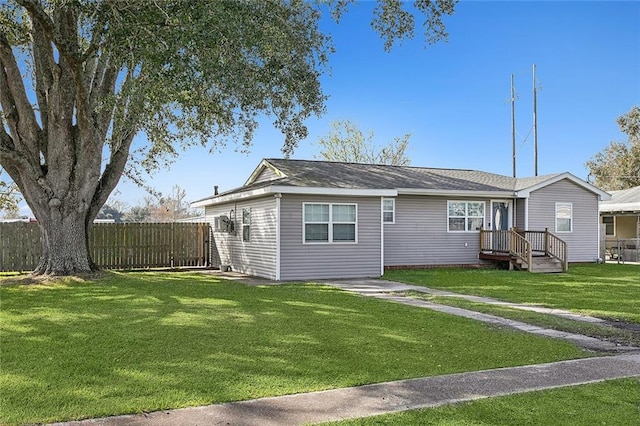 rear view of house featuring a lawn