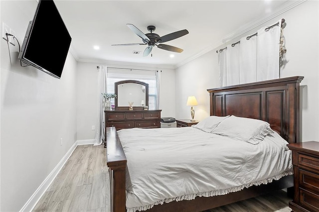 bedroom featuring ceiling fan, light hardwood / wood-style flooring, and crown molding