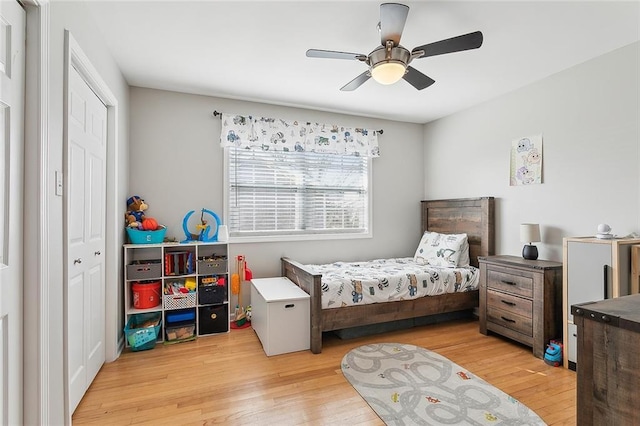 bedroom with a closet, ceiling fan, and light hardwood / wood-style flooring