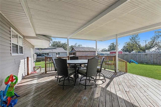 wooden terrace with a lawn