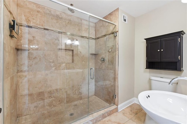 bathroom featuring sink, an enclosed shower, and tile patterned flooring