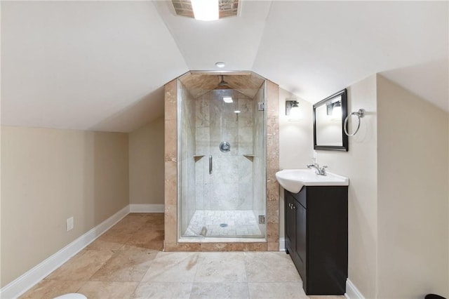 bathroom with vanity, a shower with door, and lofted ceiling