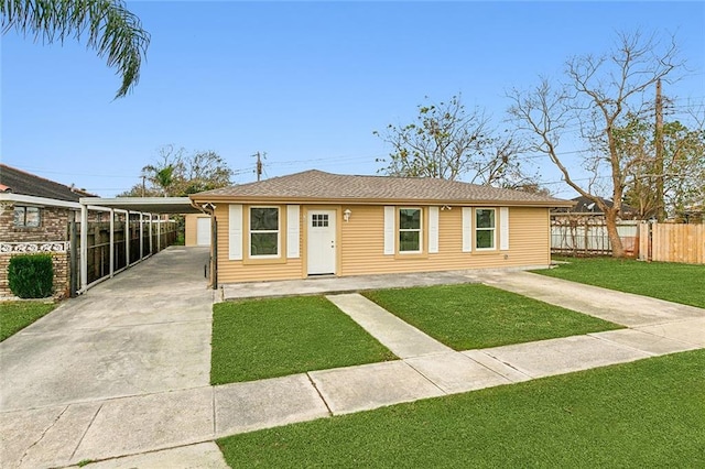 ranch-style home featuring a carport and a front lawn