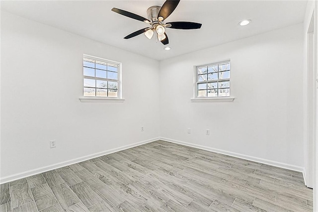 spare room with light hardwood / wood-style floors and ceiling fan