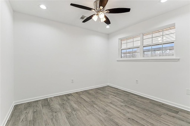 unfurnished room with ceiling fan and hardwood / wood-style flooring