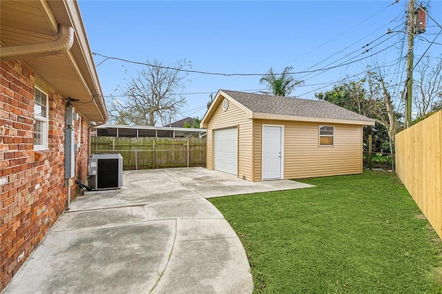 garage featuring a lawn and cooling unit