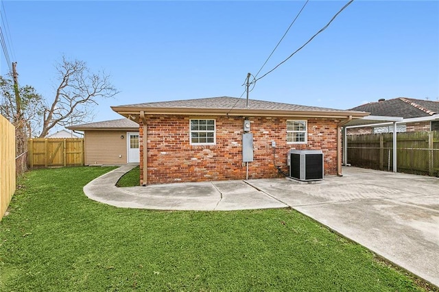 back of property featuring cooling unit, a patio area, and a lawn