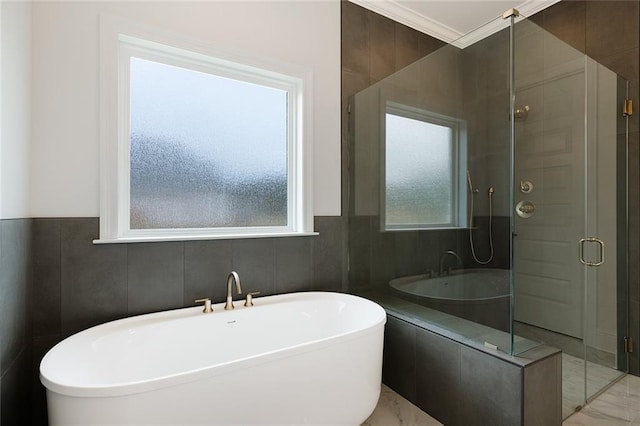 bathroom with crown molding, tile walls, and shower with separate bathtub