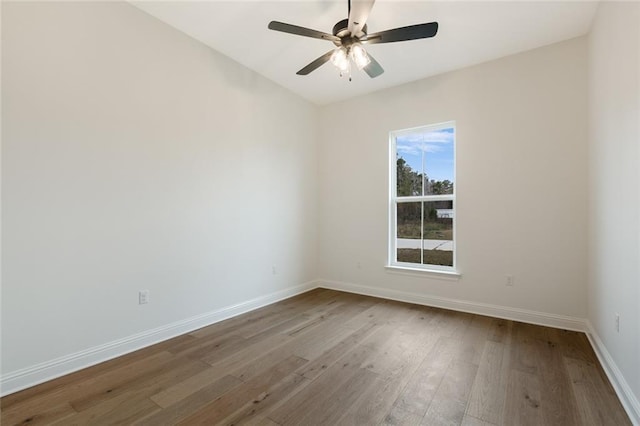 spare room featuring hardwood / wood-style flooring and ceiling fan