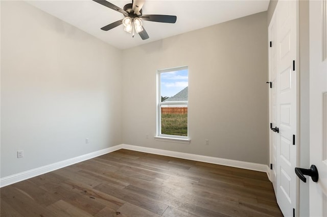 spare room with ceiling fan and dark wood-type flooring