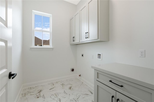 clothes washing area featuring hookup for an electric dryer, hookup for a washing machine, hookup for a gas dryer, and cabinets