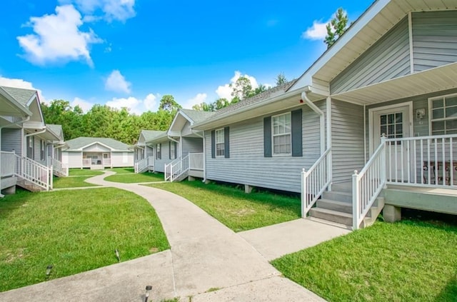 exterior space featuring covered porch and a yard