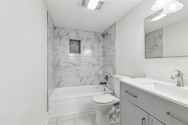 full bathroom with tile patterned floors, vanity, tiled shower / bath combo, and toilet