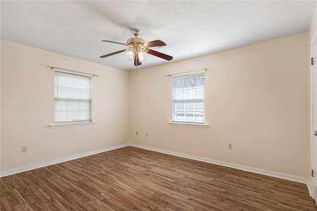 spare room with ceiling fan and dark wood-type flooring