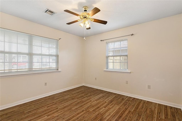 spare room with ceiling fan and dark hardwood / wood-style floors