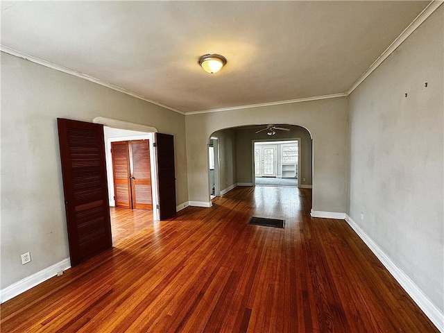 spare room featuring hardwood / wood-style flooring, ceiling fan, and crown molding