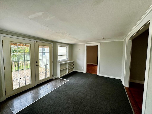 interior space with a textured ceiling and french doors