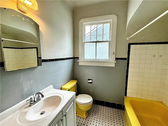 full bathroom featuring vanity, toilet, and washtub / shower combination