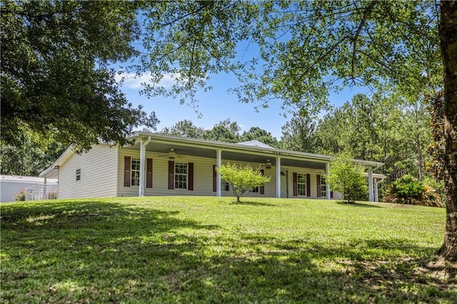 back of house with a lawn and ceiling fan