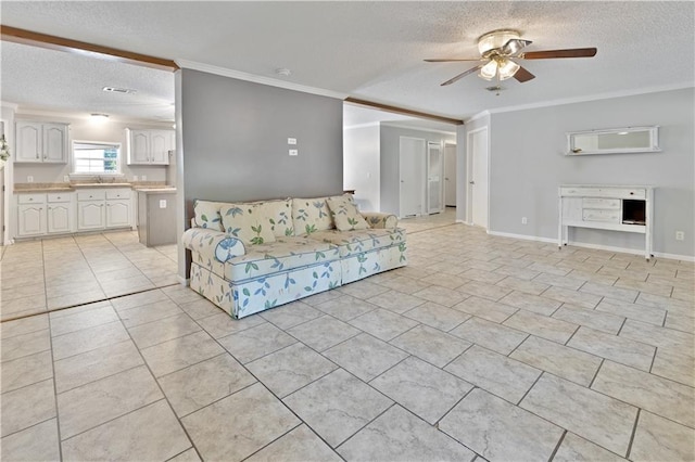 unfurnished living room with light tile patterned floors, a textured ceiling, ornamental molding, and ceiling fan