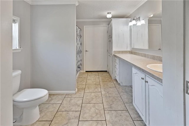 bathroom featuring toilet, vanity, ornamental molding, tile patterned floors, and a textured ceiling