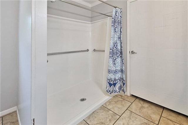 bathroom with tile patterned floors, a shower stall, and baseboards