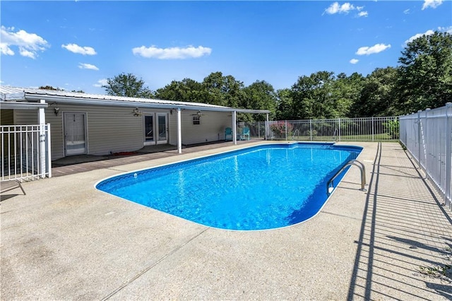 view of swimming pool with a patio, fence, and a fenced in pool