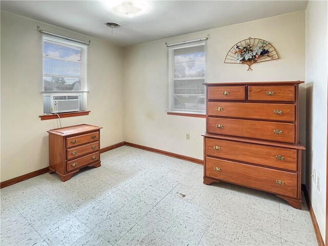 bedroom with multiple windows and cooling unit