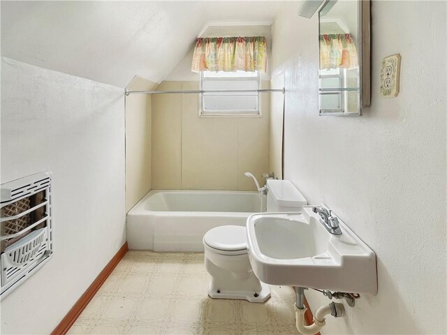 full bathroom with sink, bathing tub / shower combination, heating unit, vaulted ceiling, and toilet