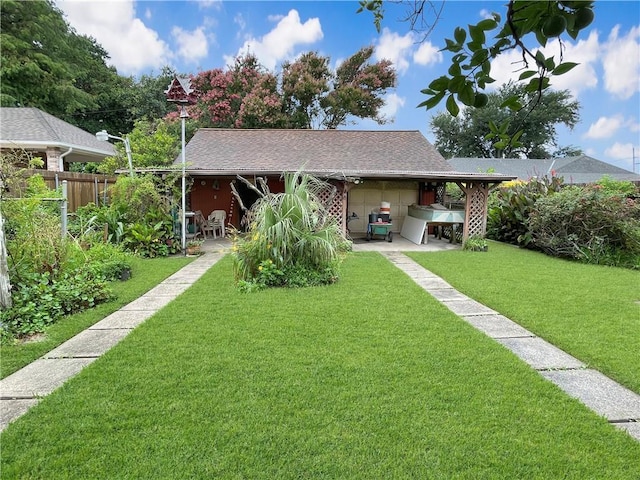 view of front of house with a carport and a front lawn