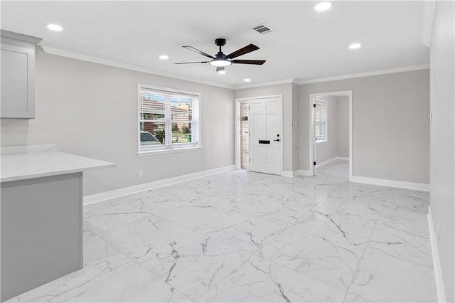 interior space featuring ceiling fan and ornamental molding