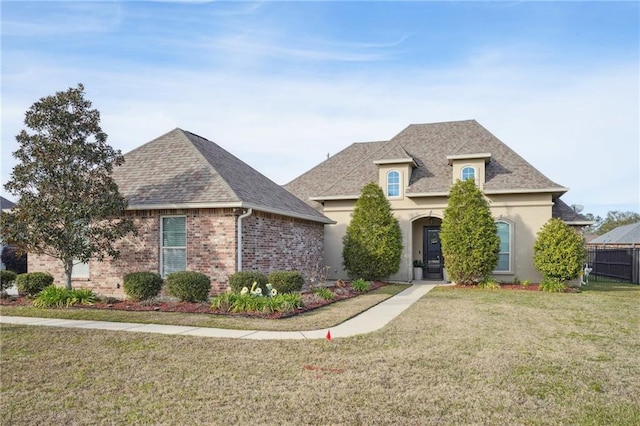 french provincial home featuring a front lawn