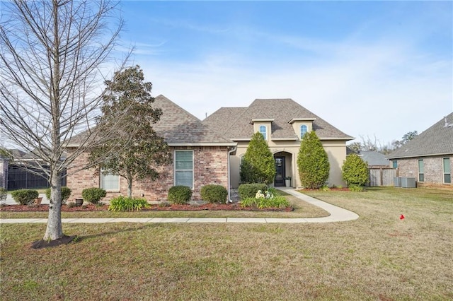 french provincial home featuring a front yard