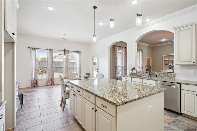 kitchen with dishwasher, a center island, sink, light stone counters, and decorative light fixtures