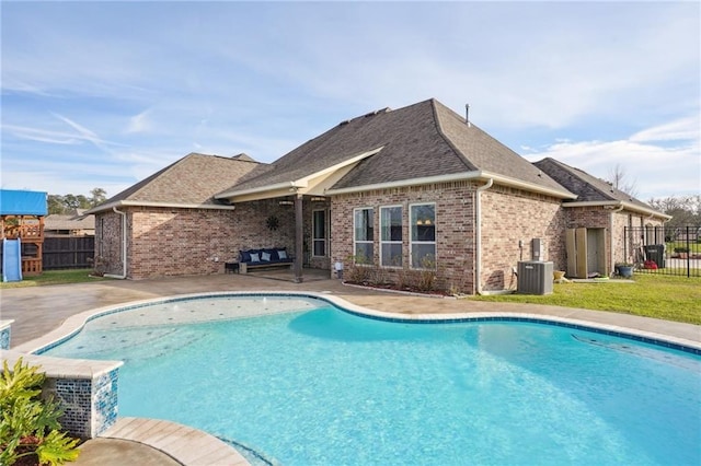 view of swimming pool featuring a patio and central air condition unit